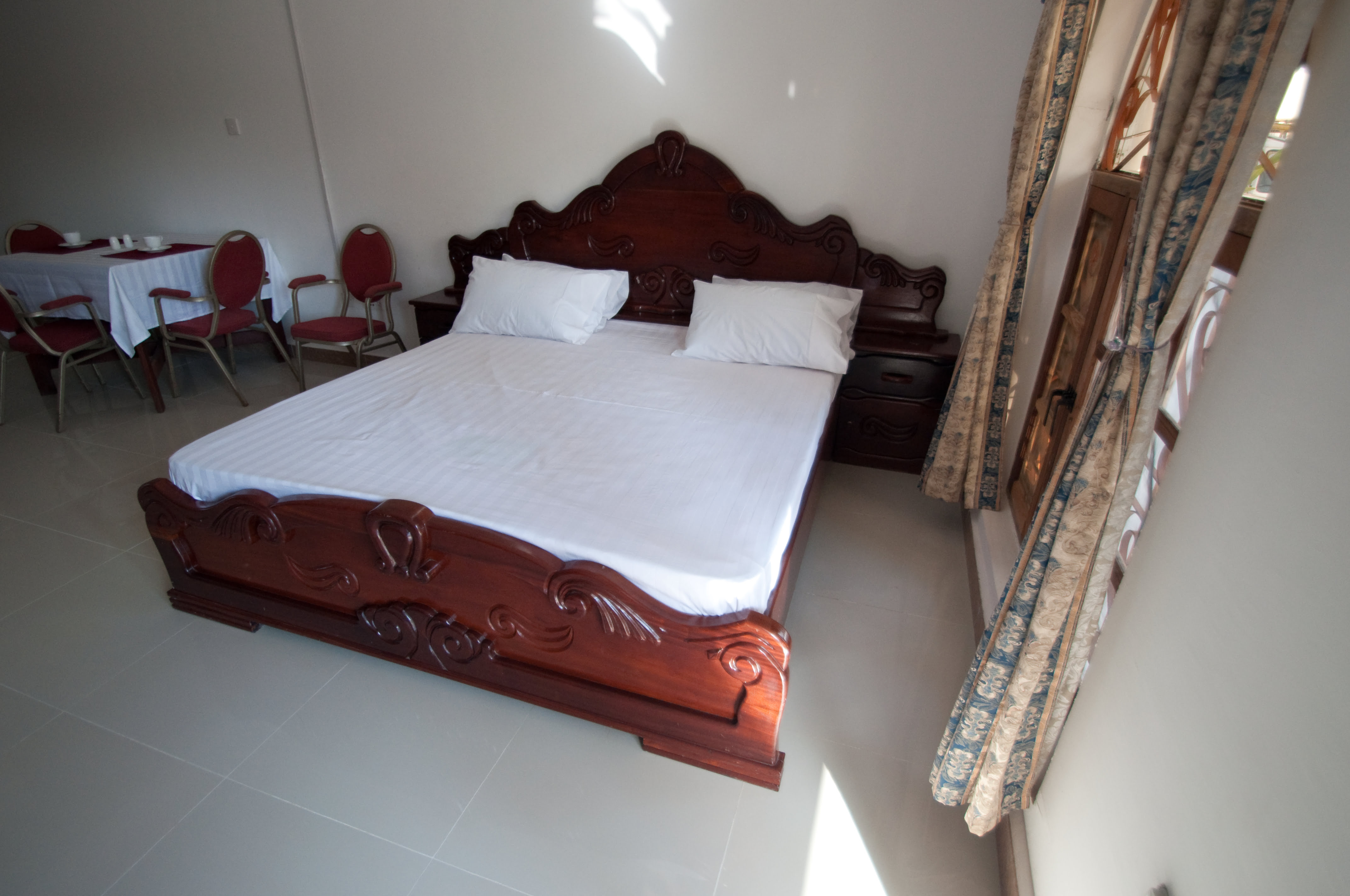 Experience comfort and luxury in our studio holiday apartment. This photo showcases the beautifully carved bed that awaits you.
